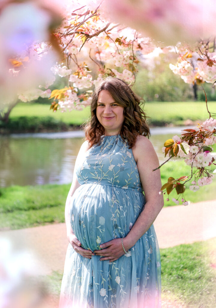 Maternity photo of pregnant woman with blossom flowers