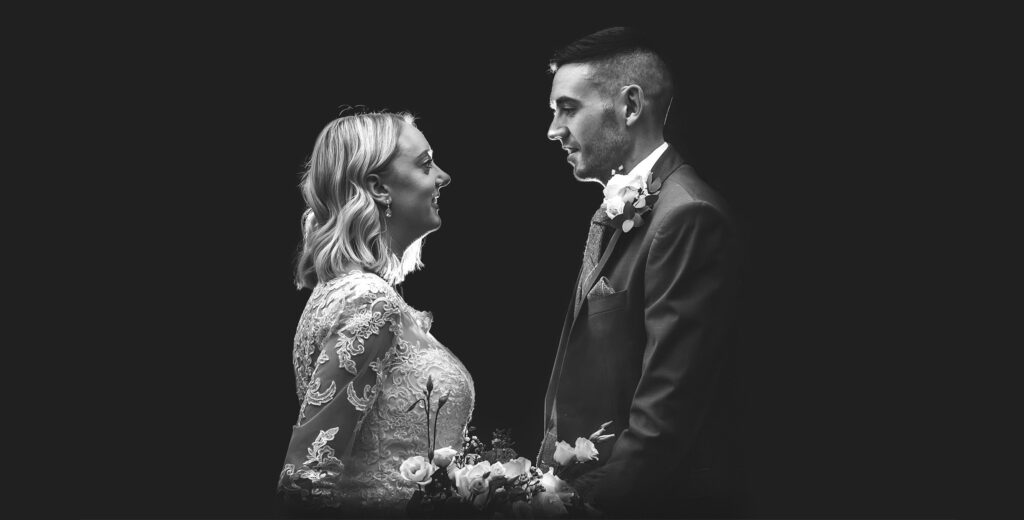 Black and white wedding photo of bride and groom with off-camera flash